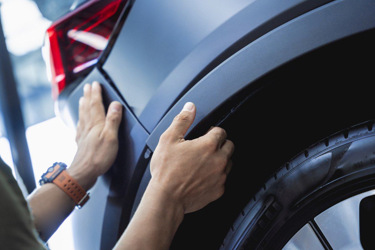 collision repair technician solving problem with vehicle