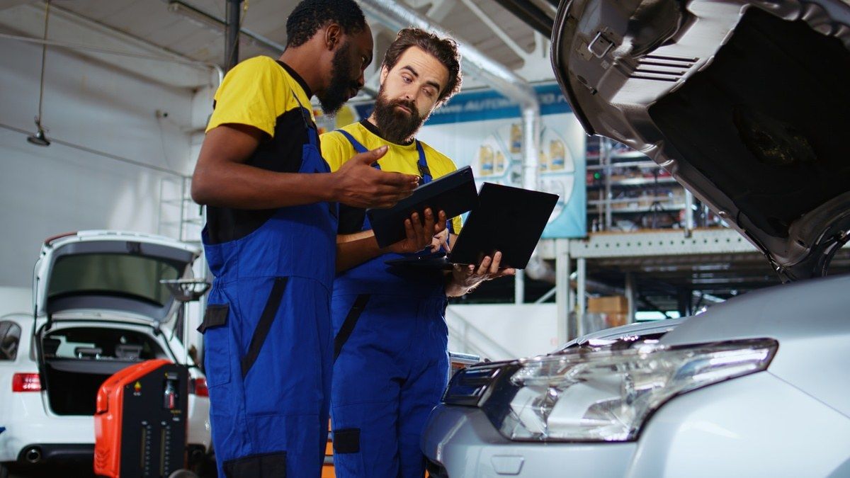 employees at collision repair center communicating and working together