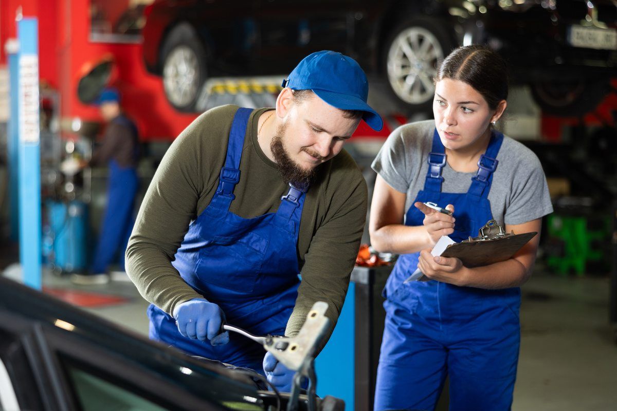 employees working together on auto body repair